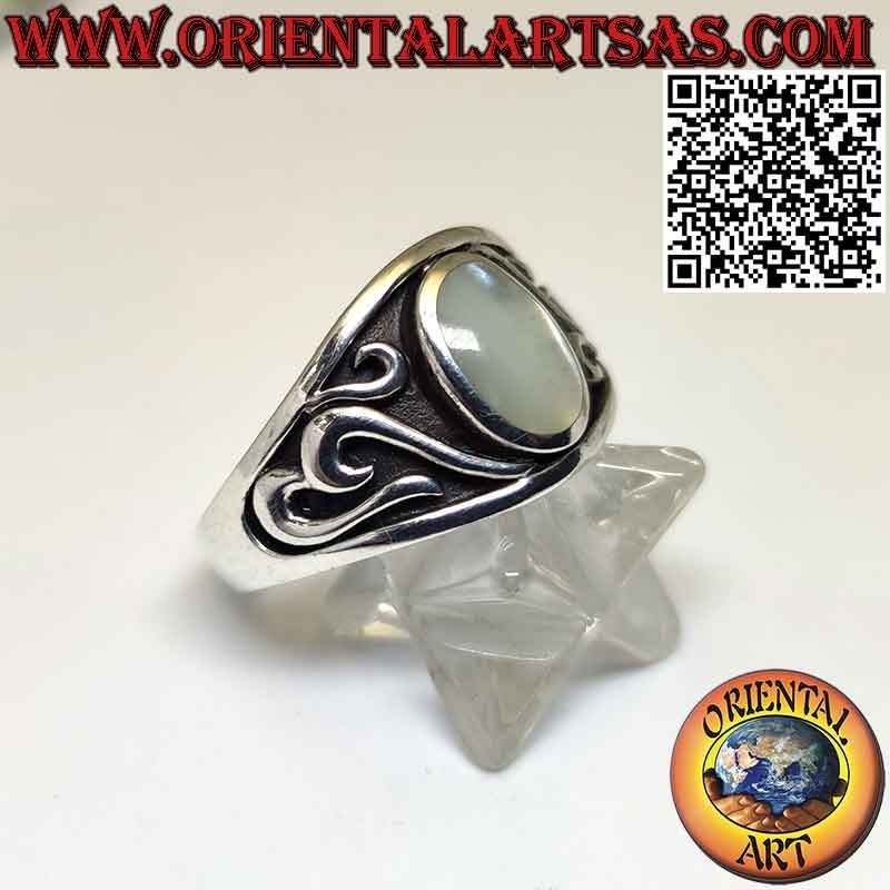 Silver ring with oval mother-of-pearl and carved high-relief decorations