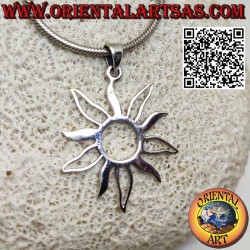 Silver pendant in the shape of the sun with alternating full and empty rays