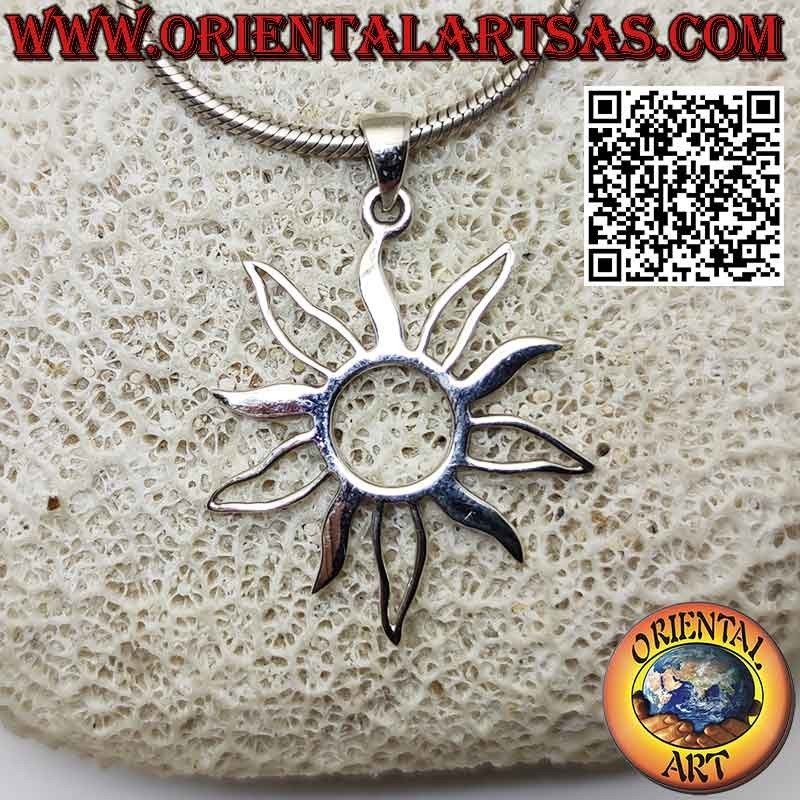 Silver pendant in the shape of the sun with alternating full and empty rays