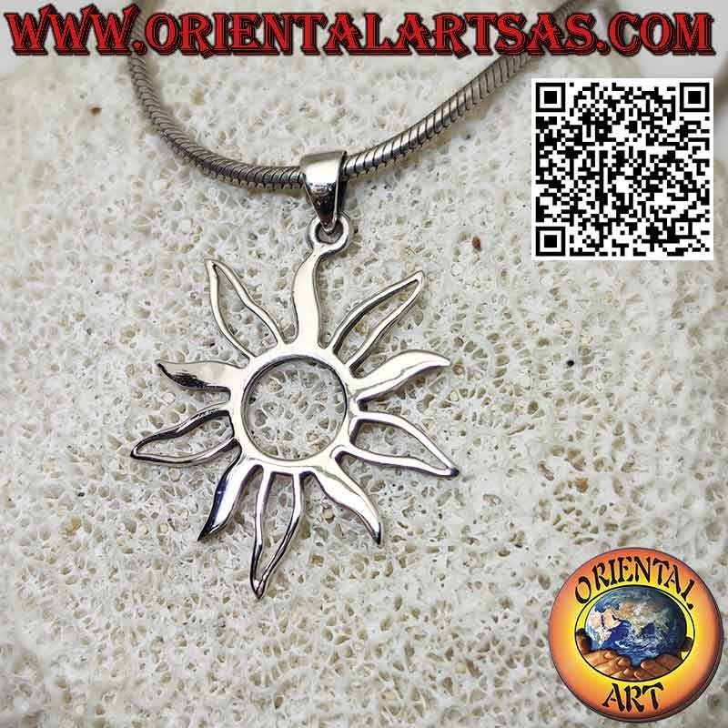 Silver pendant in the shape of the sun with alternating full and empty rays