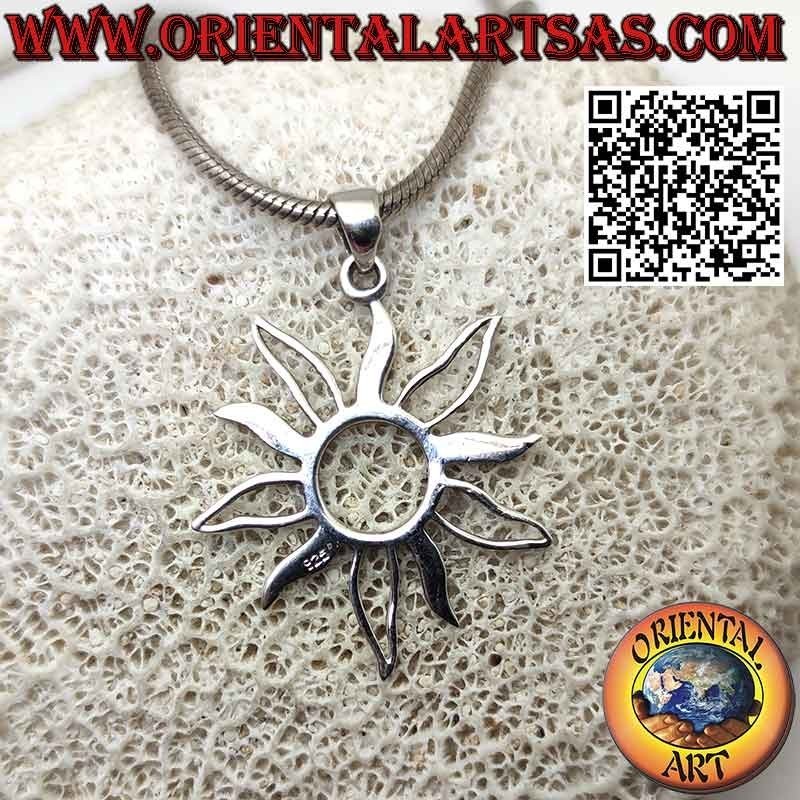 Silver pendant in the shape of the sun with alternating full and empty rays