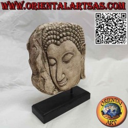 Stone sculpture of Buddha face in profile with wooden base