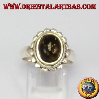 Silver ring with oval green amber