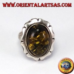 Silver ring with large green oval amber
