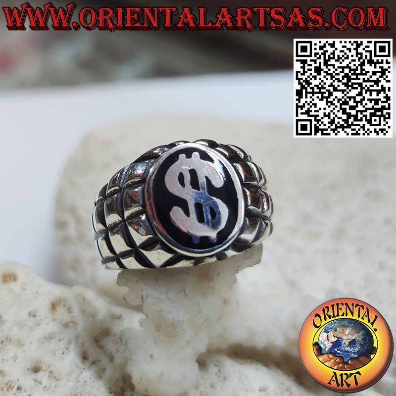 Silver ring with dollar symbol on a black and squared background