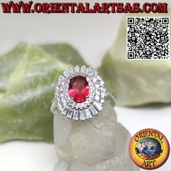 Silver ring with oval ruby surrounded by trapezoid and round zircons
