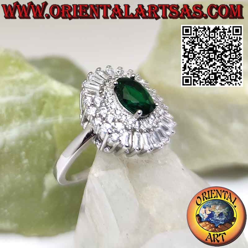 Silver ring with oval emerald surrounded by trapezoidal and round zircons