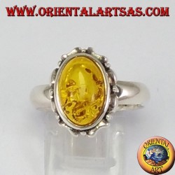 Silver ring with oval amber on carved edge