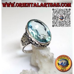Silver ring with large oval blue topaz set and decorated