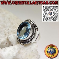 Silver ring with large oval blue topaz in a wide setting