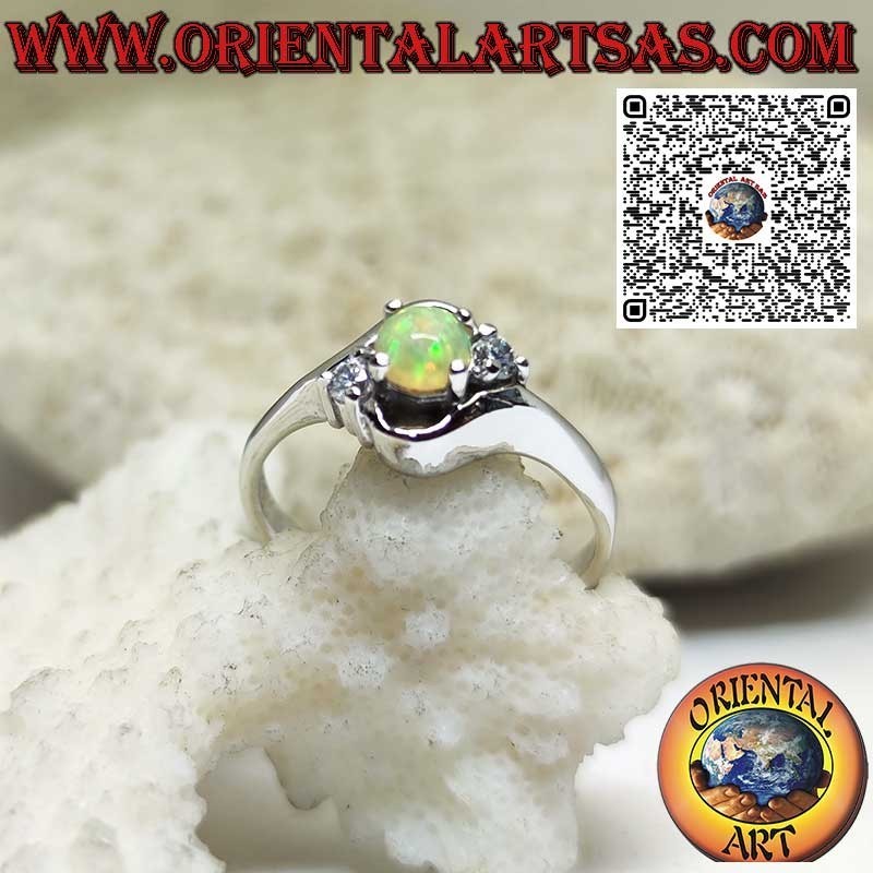 Oblique silver ring with round harlequin opal and two zircons