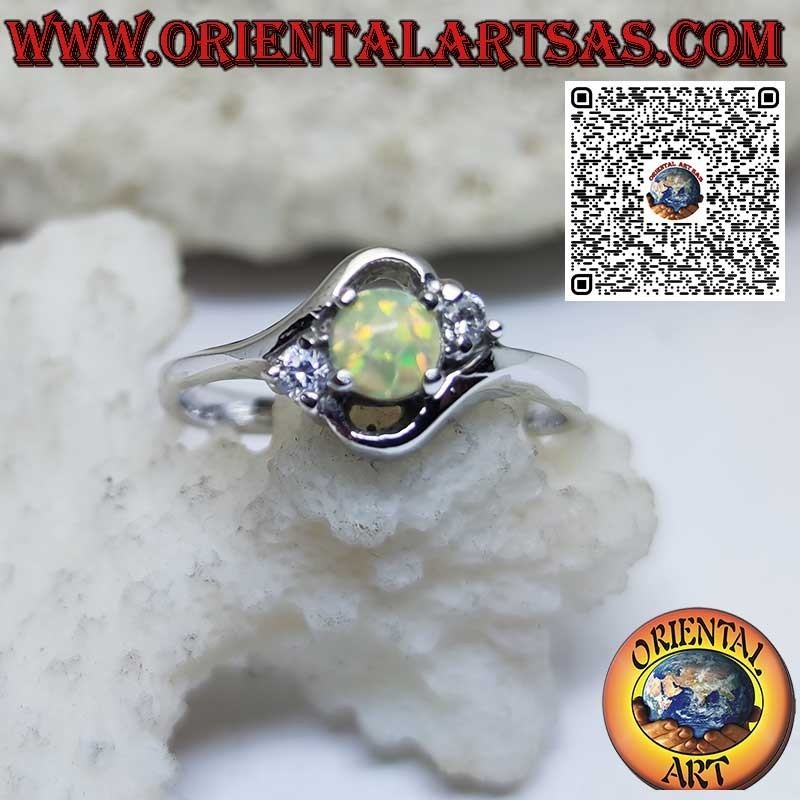 Oblique silver ring with round harlequin opal and two zircons