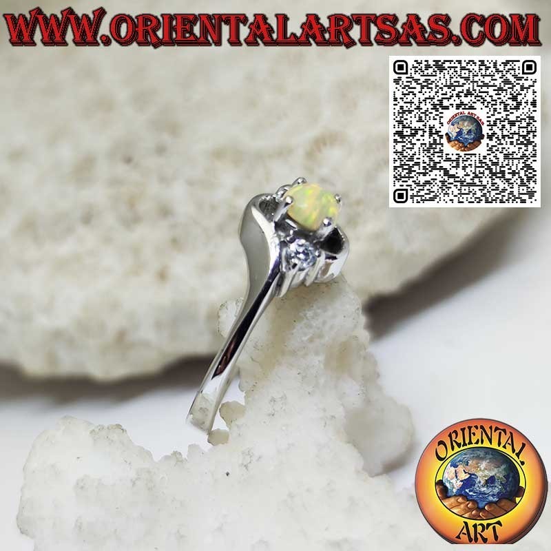 Oblique silver ring with round harlequin opal and two zircons
