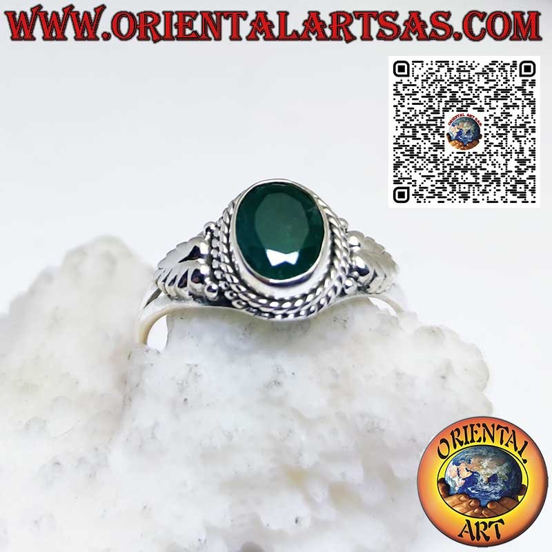Silver ring with oval natural emerald and decorations on the sides
