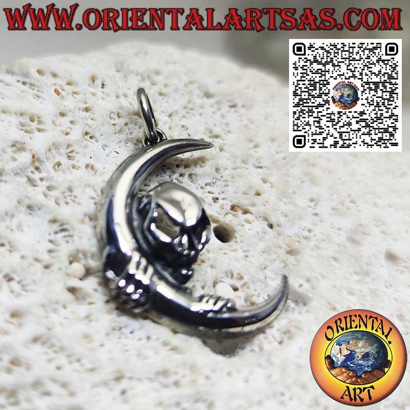 Silver pendant skull of darkness clinging to the moon