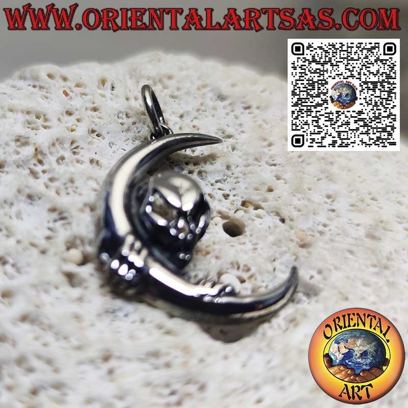 Silver pendant skull of darkness clinging to the moon