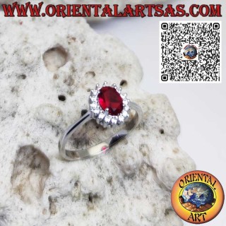 Silver ring with oval garnet set surrounded by zircons