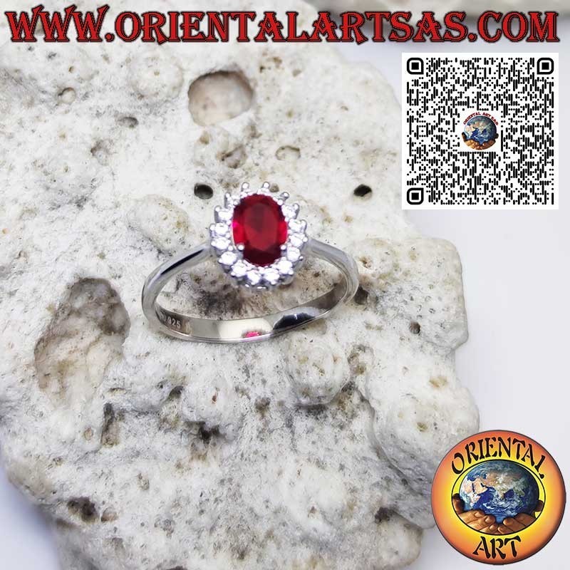 Silver ring with oval garnet set surrounded by zircons