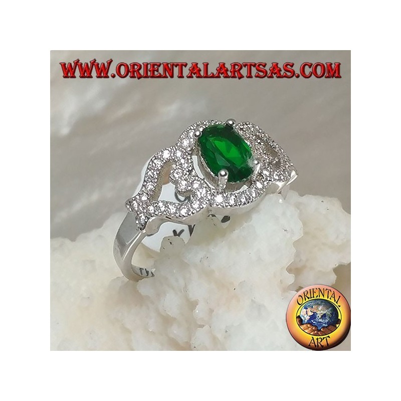 Anillo de plata con esmeralda sintética ovalada en el marco con corazones en los lados tachonados con circonitas