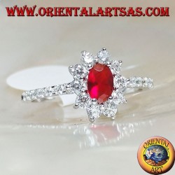 Silver ring with small oval garnet set surrounded by cubic zirconia and row on the sides