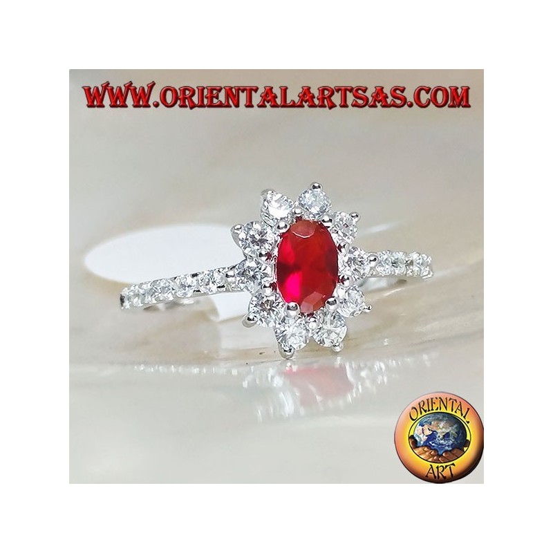 Silver ring with small oval garnet set surrounded by cubic zirconia and row on the sides