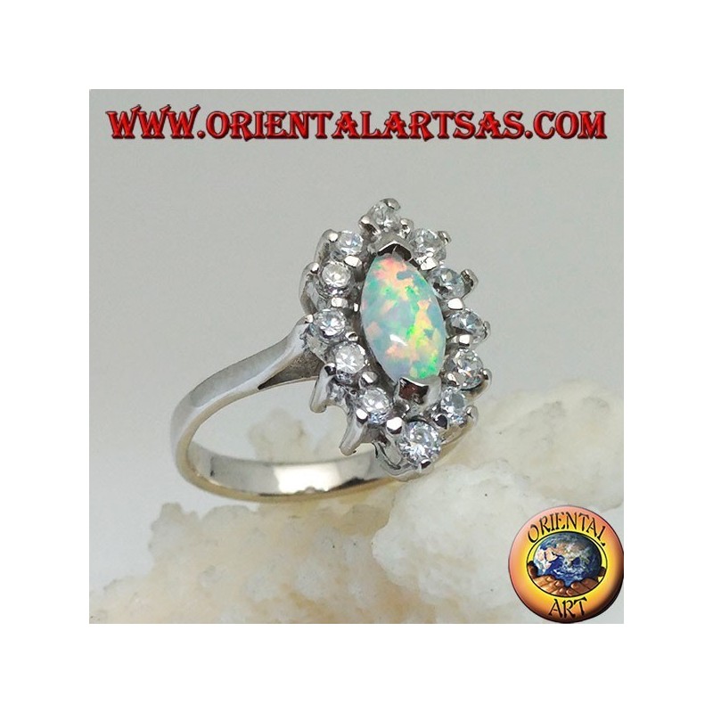 Silver ring with shuttle harlequin opal set on the tips surrounded by zircons