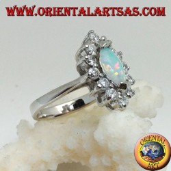 Silver ring with shuttle harlequin opal set on the tips surrounded by zircons
