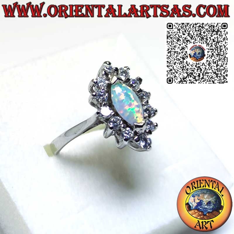 Silver ring with shuttle harlequin opal set on the tips surrounded by zircons