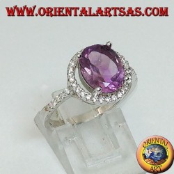 Silver ring with natural amethyst suspended on a circle of zircons