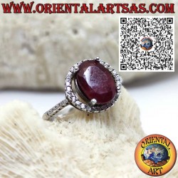 Silver ring with a natural garnet suspended on a circle of zircons