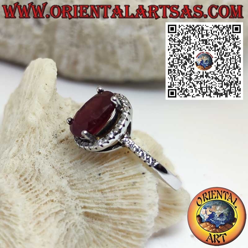 Silver ring with a natural garnet suspended on a circle of zircons