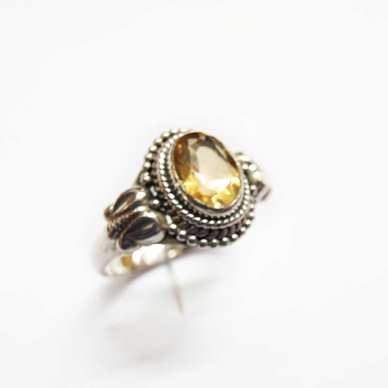 Silver ring with natural oval yellow topaz and side decorations