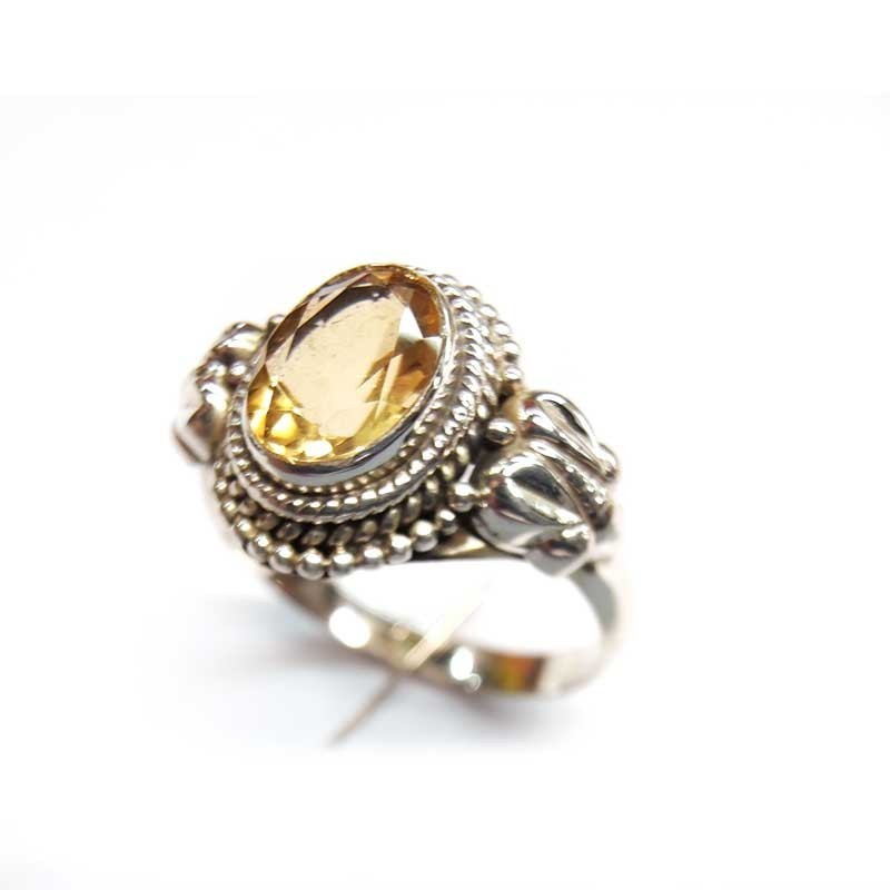 Silver ring with natural oval yellow topaz and side decorations