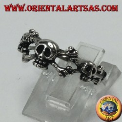 Silver ring with three skulls with bone